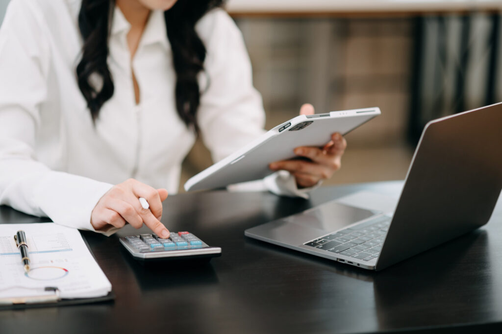 Businesswoman using on smartphone and tablet and laptop at moderm office as concept